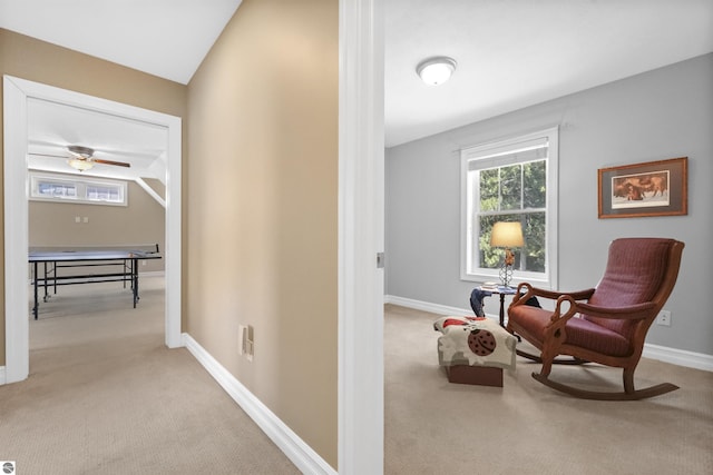 living area with lofted ceiling and light carpet