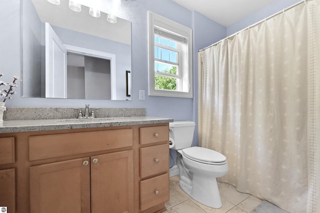 bathroom featuring tile patterned flooring, vanity, and toilet