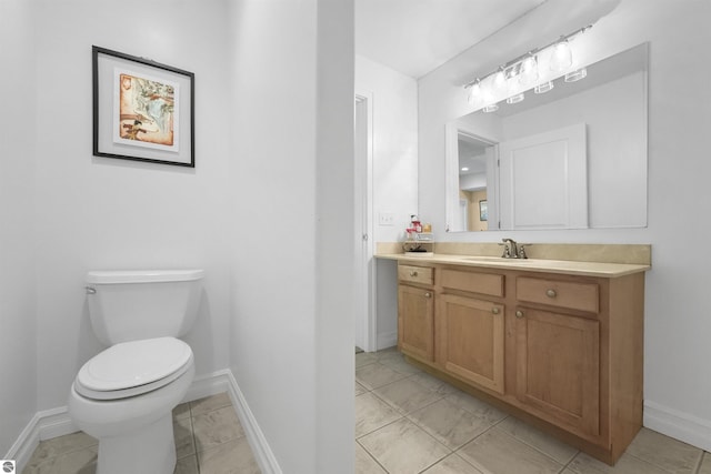 bathroom featuring vanity, toilet, and tile patterned flooring