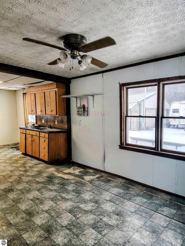 kitchen with a textured ceiling and ceiling fan