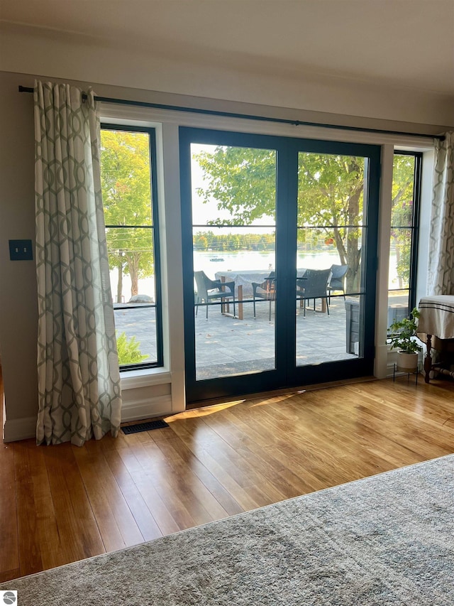 doorway with hardwood / wood-style floors