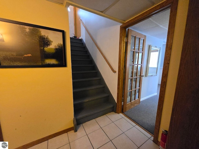 stairs featuring tile patterned flooring