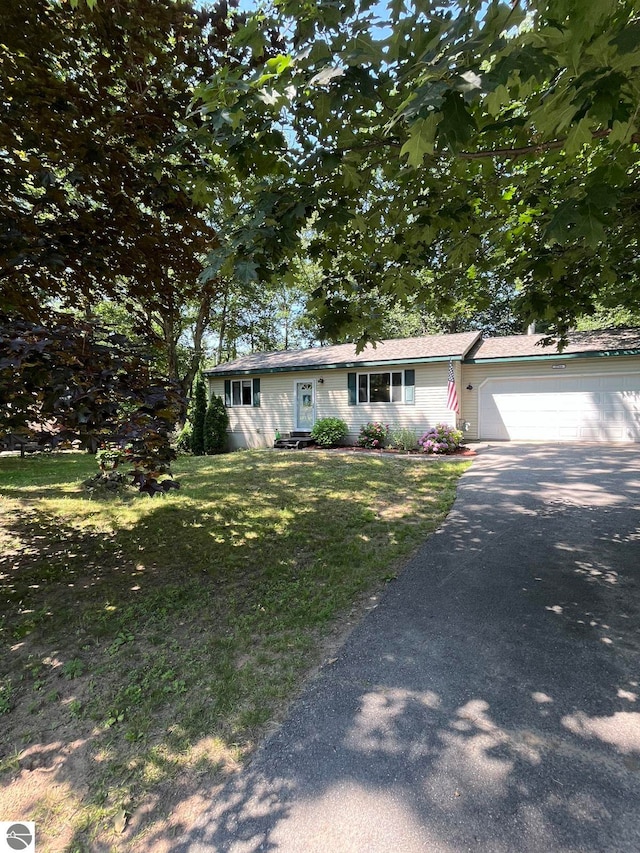 view of front of house with a garage and a front yard