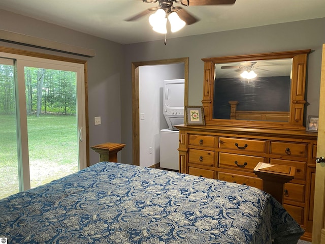 bedroom featuring access to exterior, ceiling fan, and stacked washer / dryer