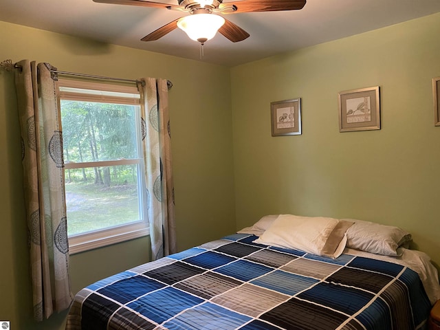 bedroom featuring multiple windows and ceiling fan