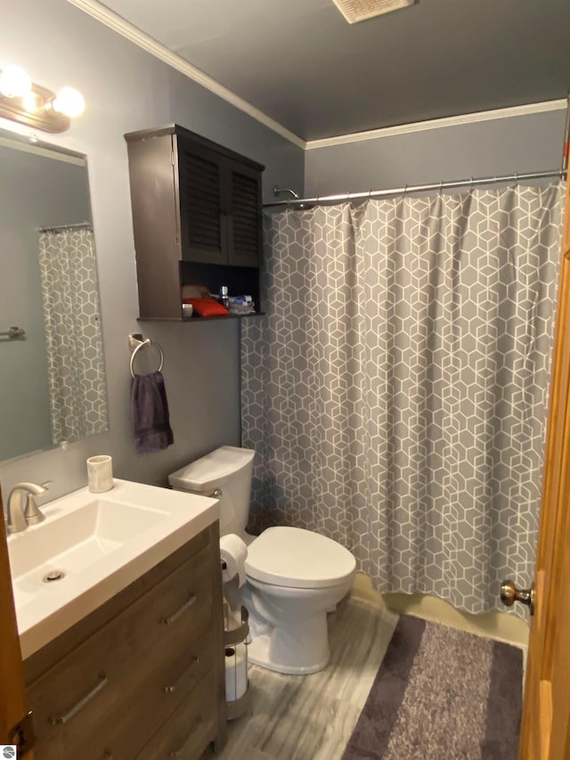 bathroom with crown molding, curtained shower, vanity, and toilet