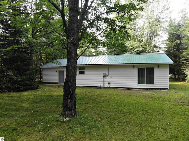 back of property featuring a lawn