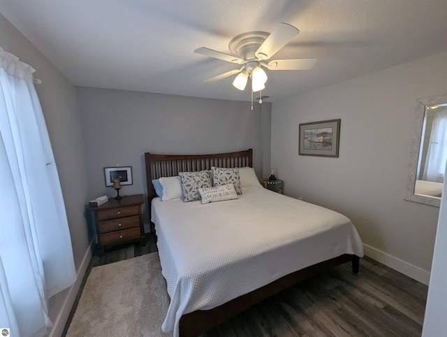 bedroom with dark wood-type flooring and ceiling fan