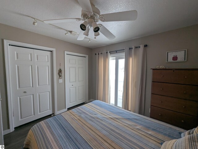 bedroom featuring multiple closets, ceiling fan, and a textured ceiling