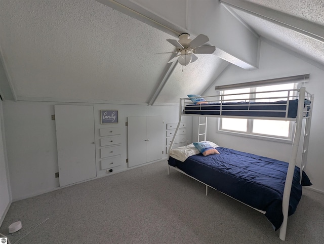 carpeted bedroom with ceiling fan, vaulted ceiling with beams, and a textured ceiling