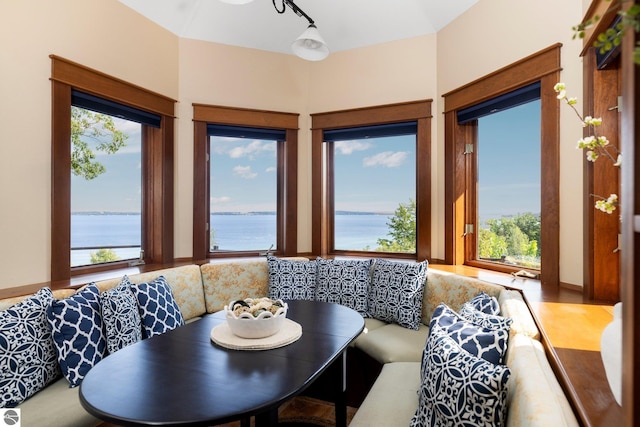 dining room featuring breakfast area, hardwood / wood-style floors, and a water view