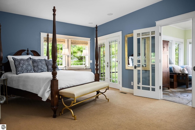 carpeted bedroom with access to exterior and french doors