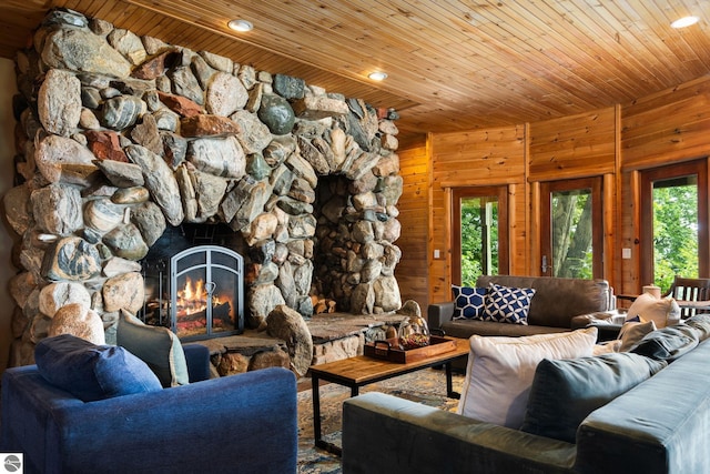 unfurnished living room with a fireplace, wooden ceiling, and wood walls