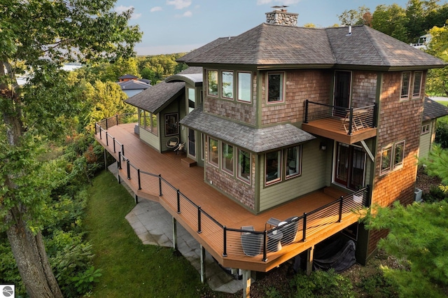 back of property featuring a lawn and central air condition unit