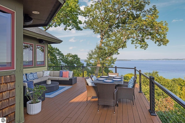 deck with an outdoor hangout area and a water view