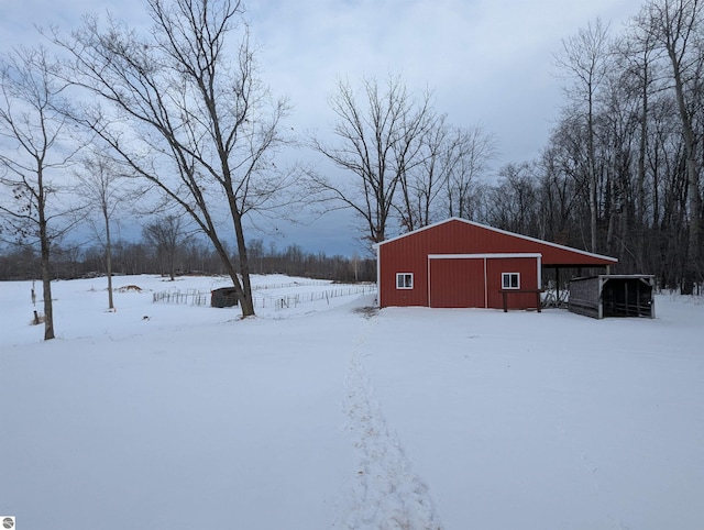 yard covered in snow featuring an outbuilding