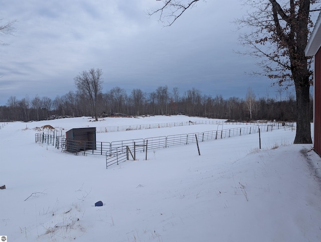 snowy yard featuring a rural view