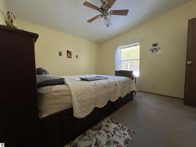 carpeted bedroom featuring vaulted ceiling and ceiling fan