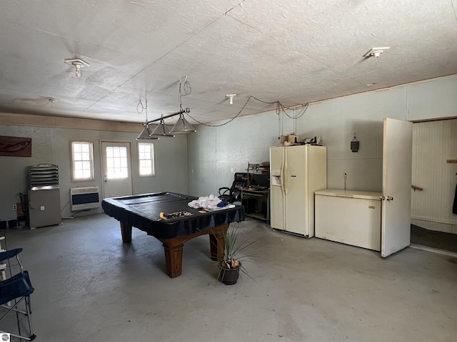 game room with heating unit, pool table, and concrete floors