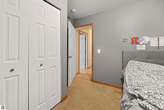 bedroom with light carpet and a closet