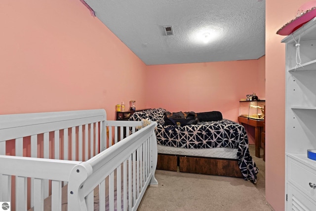 carpeted bedroom with a textured ceiling