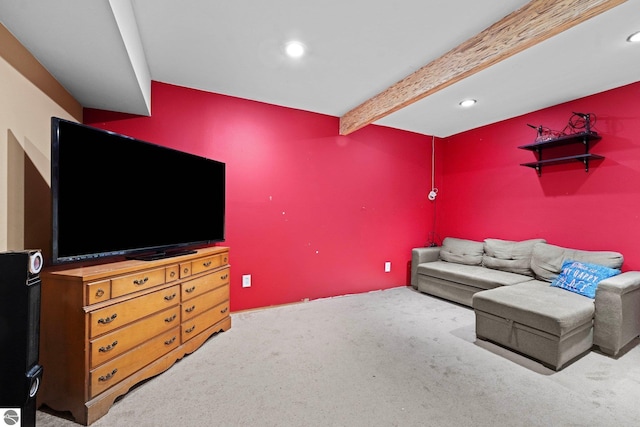 living room with beamed ceiling and carpet