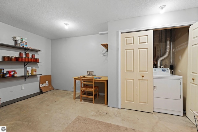 clothes washing area with washer / clothes dryer and a textured ceiling