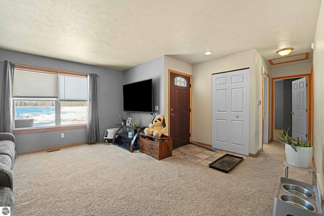 living room featuring light carpet and a textured ceiling