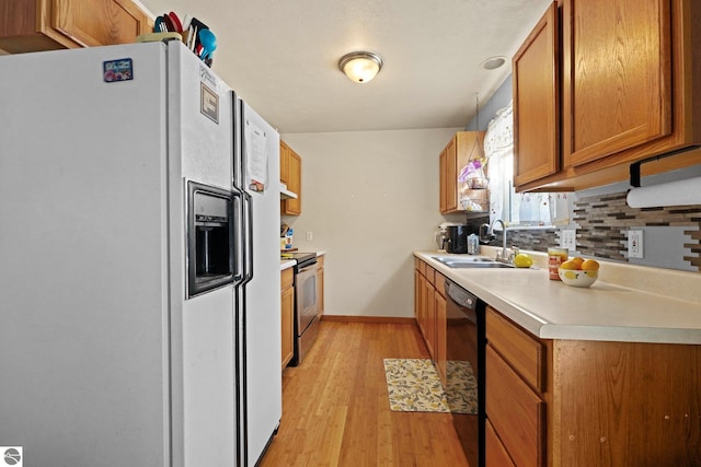 kitchen featuring electric stove, sink, dishwasher, hanging light fixtures, and white refrigerator with ice dispenser