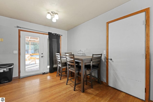 dining space featuring hardwood / wood-style flooring and a chandelier