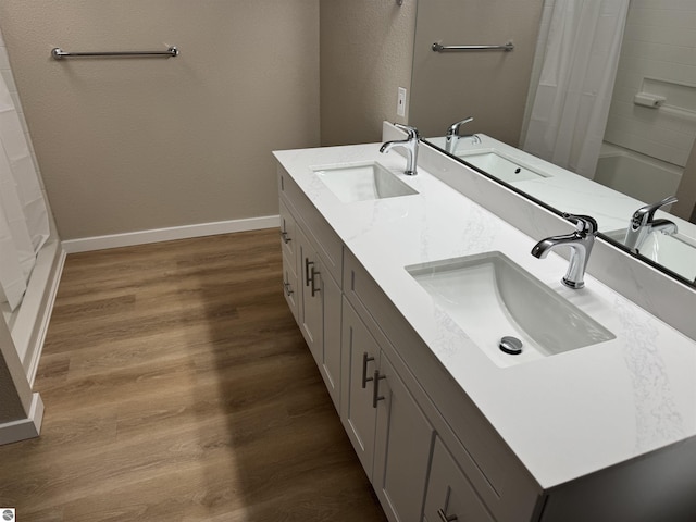 bathroom with vanity, hardwood / wood-style floors, and shower / tub combo with curtain