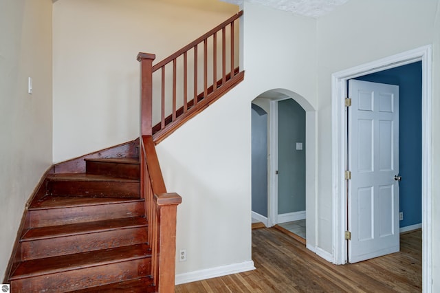 stairs with hardwood / wood-style flooring