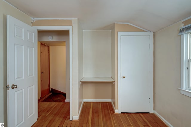 interior space featuring vaulted ceiling and light wood-type flooring