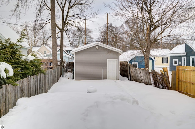 snowy yard with an outbuilding