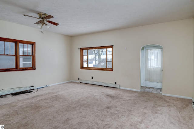 carpeted spare room with a textured ceiling, a baseboard radiator, and ceiling fan