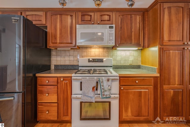 kitchen featuring white appliances and decorative backsplash