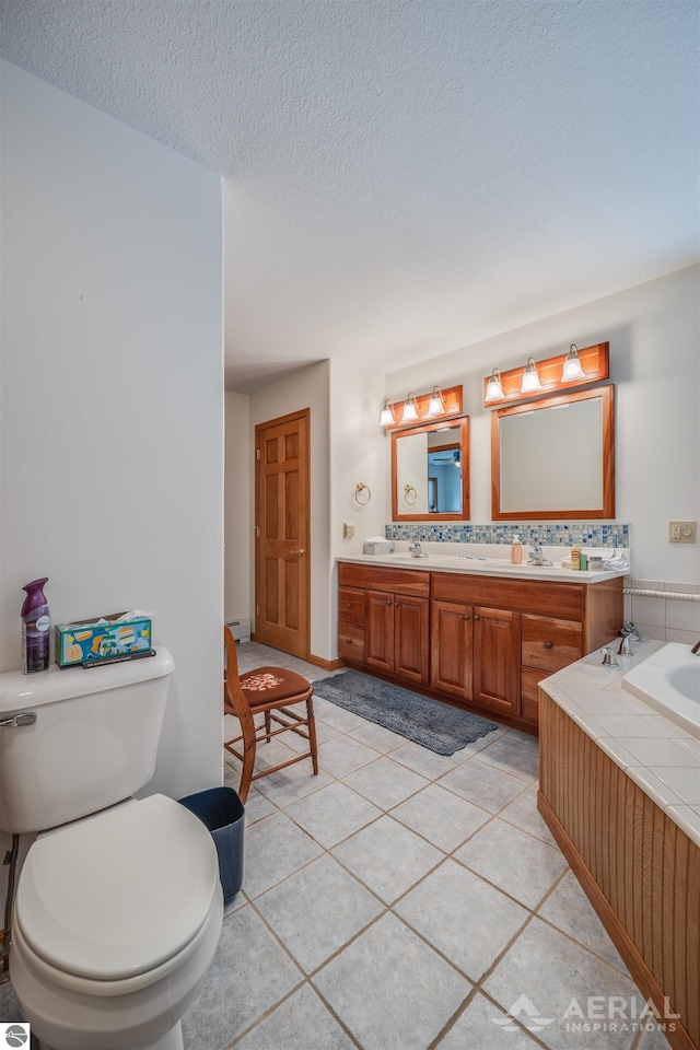 bathroom with vanity, toilet, tile patterned flooring, and a textured ceiling