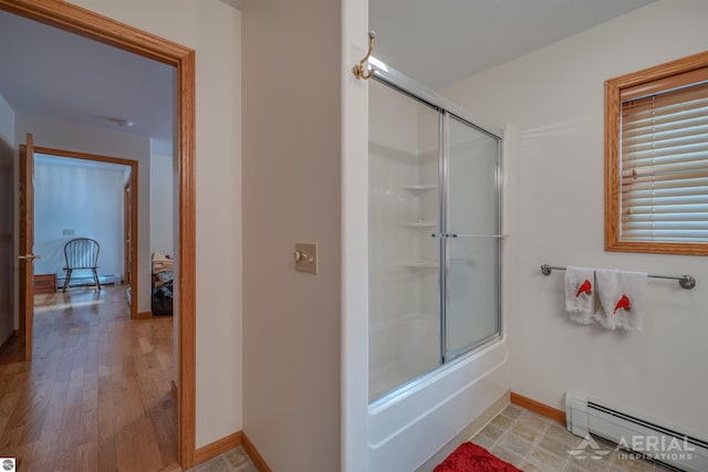 bathroom featuring a baseboard radiator and bath / shower combo with glass door