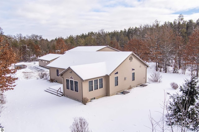 view of snow covered rear of property