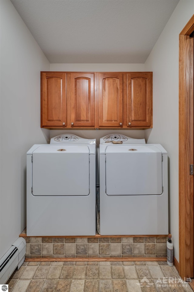 laundry area with washer and clothes dryer, cabinets, and baseboard heating