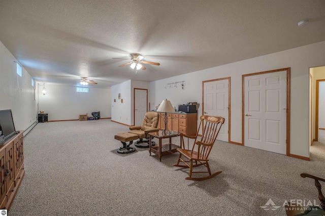 sitting room featuring ceiling fan, a textured ceiling, and carpet flooring