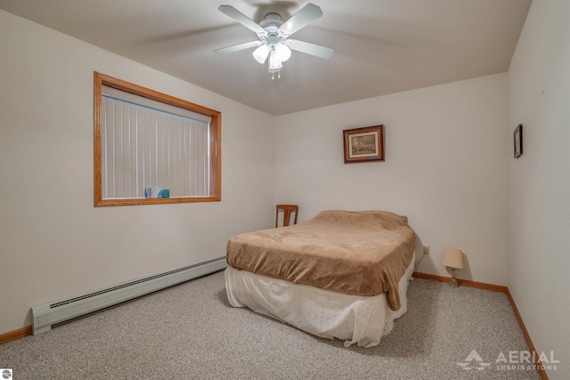 carpeted bedroom featuring baseboard heating and ceiling fan