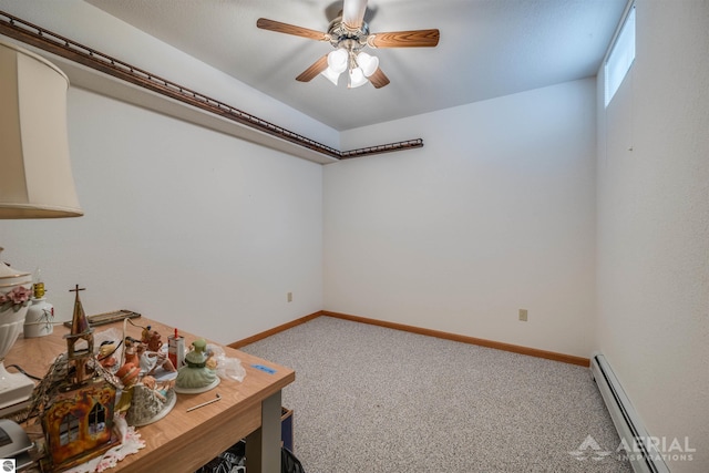 interior space with ceiling fan, carpet floors, and baseboard heating