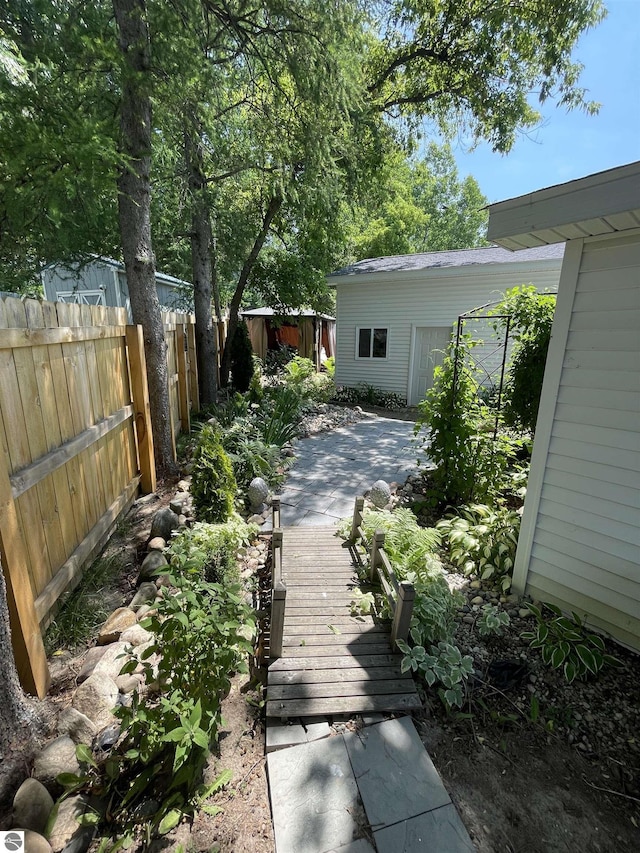 view of yard featuring an outdoor structure and a patio