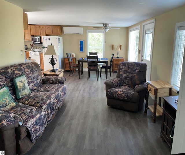 living room with dark hardwood / wood-style floors, a wall mounted AC, and ceiling fan