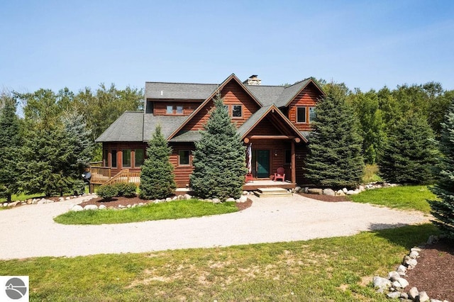 log home with a front lawn