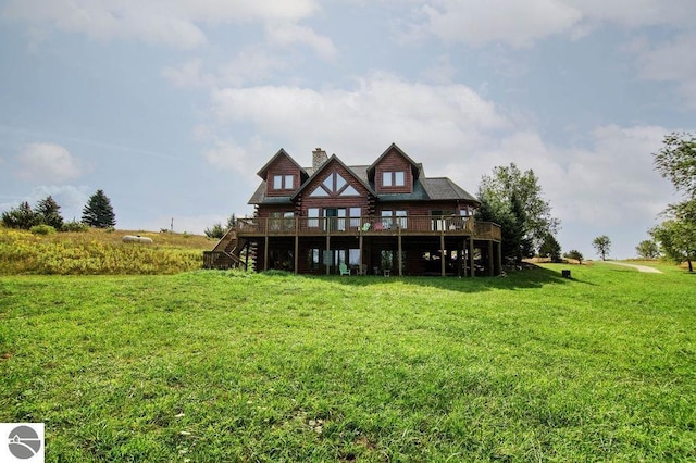 rear view of property with a yard and a deck