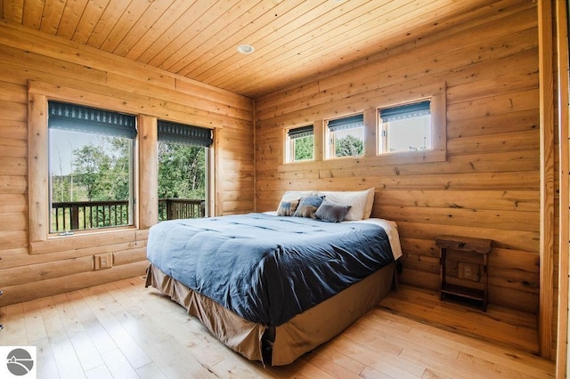 bedroom with multiple windows, light wood-type flooring, and wood ceiling