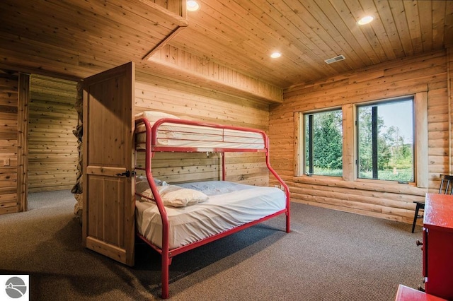 bedroom with log walls, carpet, wooden ceiling, and wooden walls