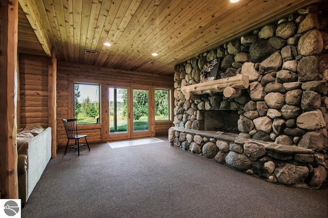 interior space with log walls, a stone fireplace, carpet floors, and wooden ceiling